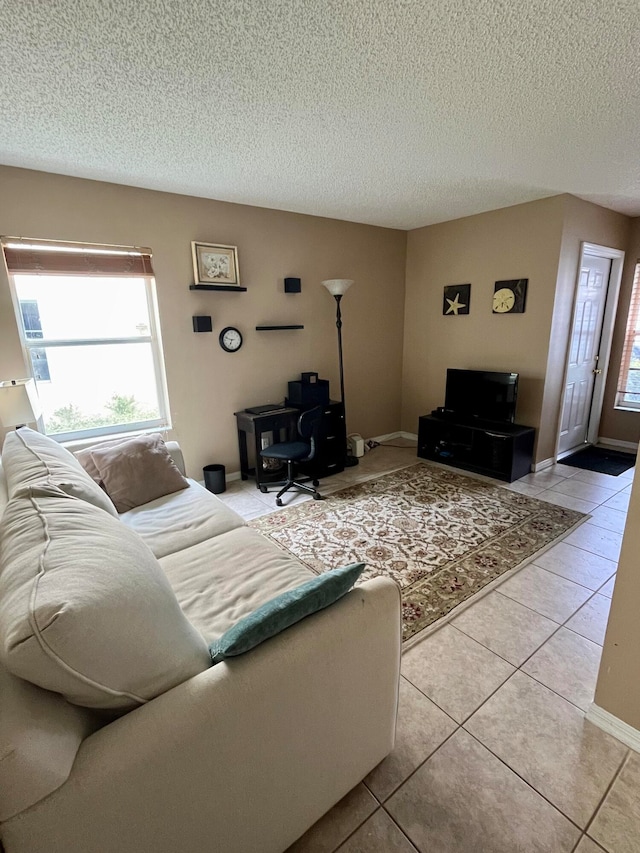 living room with light tile patterned floors and a textured ceiling