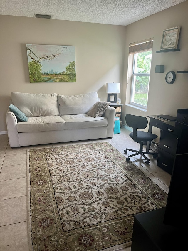home office with visible vents, light tile patterned floors, and a textured ceiling
