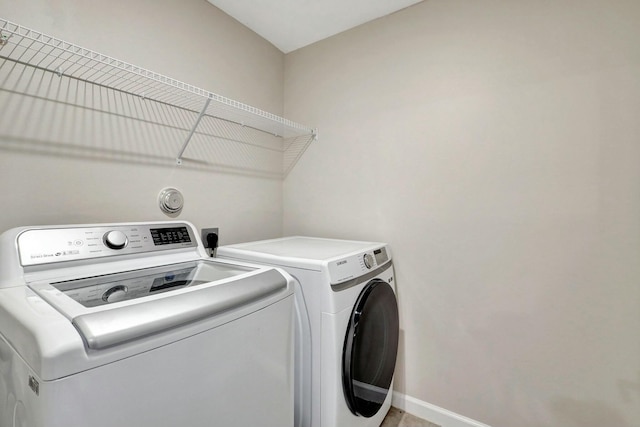 laundry room featuring washing machine and clothes dryer