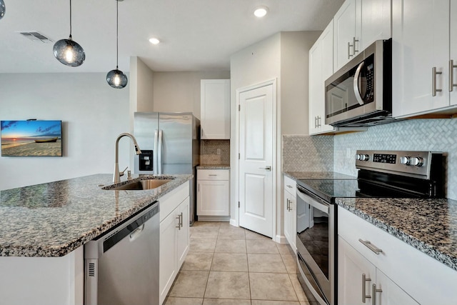 kitchen featuring white cabinets, decorative light fixtures, sink, and appliances with stainless steel finishes