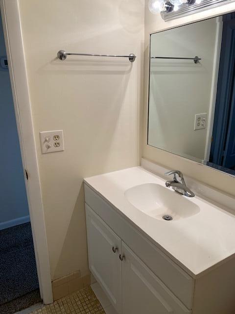 bathroom featuring tile patterned flooring and vanity