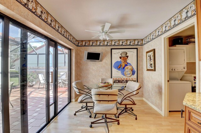 dining room with ceiling fan, stacked washer / dryer, light wood-type flooring, and french doors