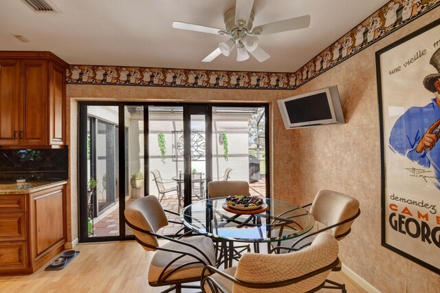 dining room featuring light hardwood / wood-style flooring and ceiling fan