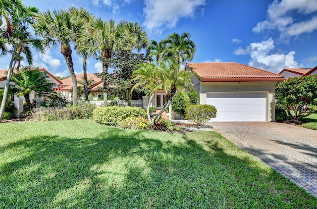 mediterranean / spanish home with a front yard and a garage