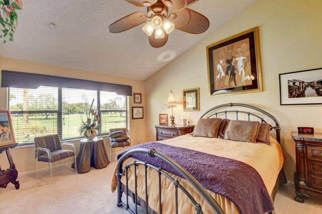 carpeted bedroom featuring a textured ceiling, ceiling fan, and vaulted ceiling