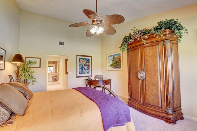 bedroom featuring a textured ceiling, carpet flooring, ceiling fan, and ensuite bathroom