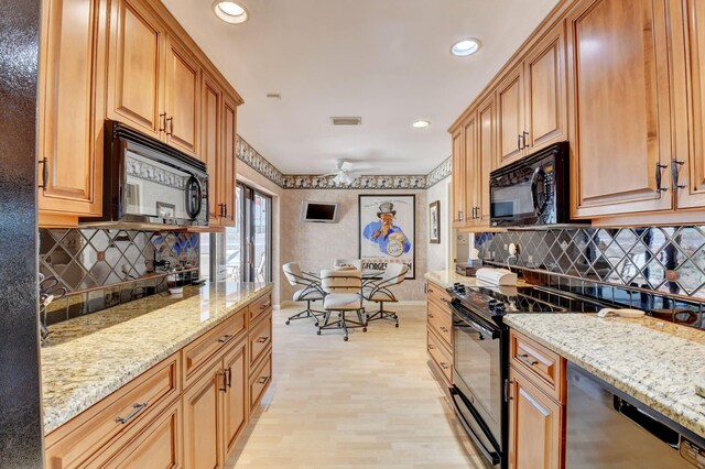 kitchen featuring black appliances, light hardwood / wood-style flooring, ceiling fan, and light stone countertops