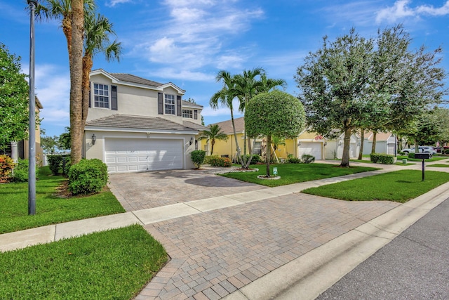 view of front of property featuring a garage and a front lawn