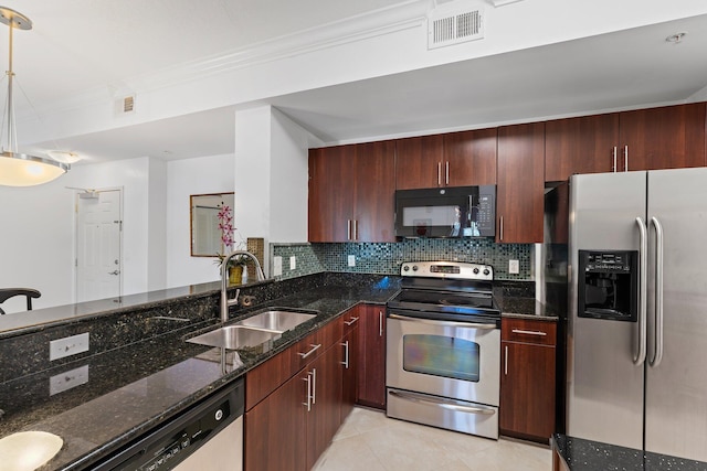 kitchen with sink, dark stone counters, decorative light fixtures, light tile patterned floors, and appliances with stainless steel finishes