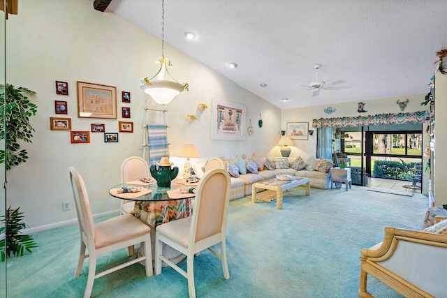 dining area featuring high vaulted ceiling, carpet, ceiling fan, and a textured ceiling