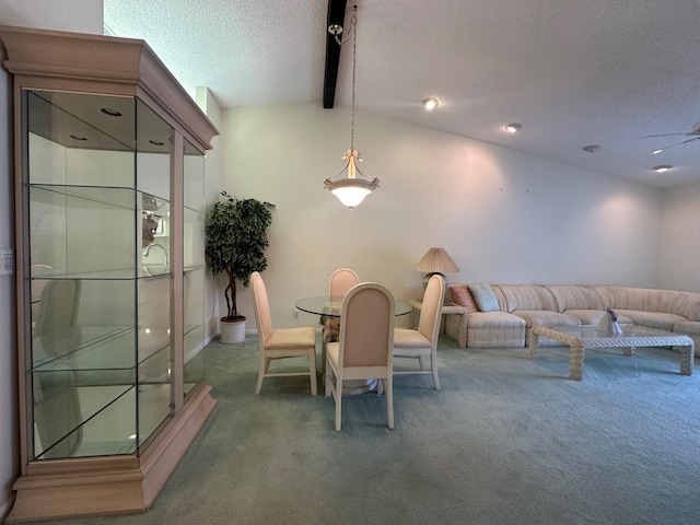 dining area with carpet, a textured ceiling, and lofted ceiling with beams
