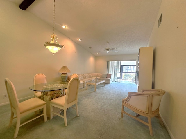 carpeted dining room with vaulted ceiling, visible vents, baseboards, and ceiling fan