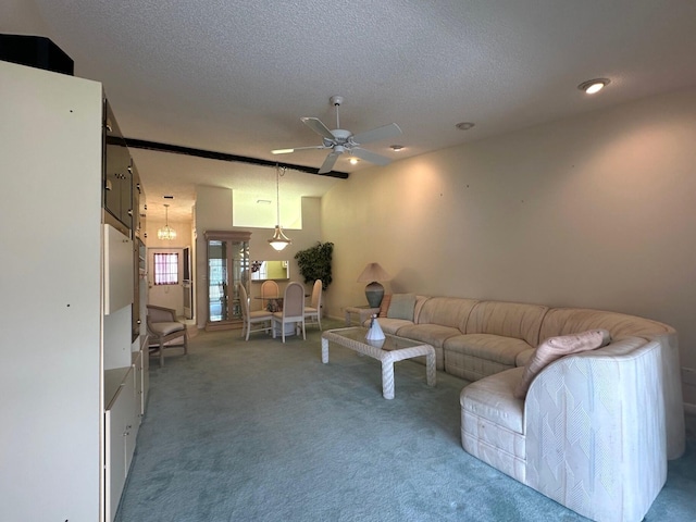 living area with a textured ceiling, light carpet, and a ceiling fan