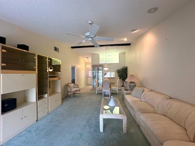 carpeted living room featuring a textured ceiling, visible vents, and a ceiling fan