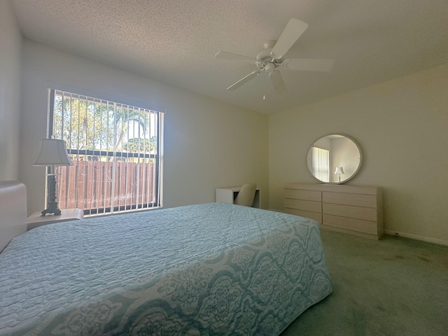 bedroom featuring a textured ceiling, carpet flooring, and a ceiling fan