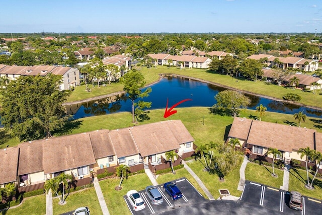 birds eye view of property with a water view and a residential view