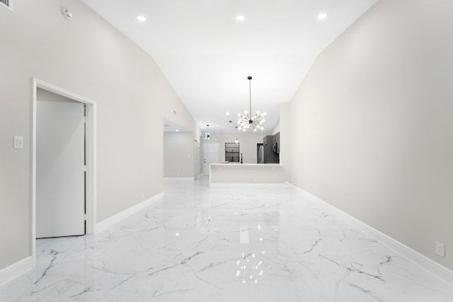 interior space with a towering ceiling and a chandelier