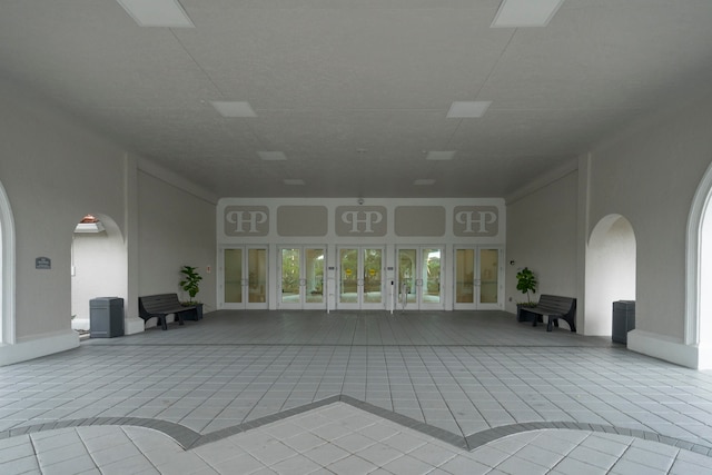 interior space featuring french doors and light tile patterned floors