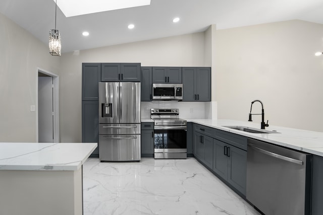 kitchen featuring light stone counters, appliances with stainless steel finishes, lofted ceiling with skylight, and sink