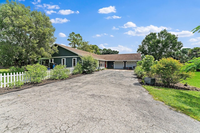 ranch-style home featuring a garage