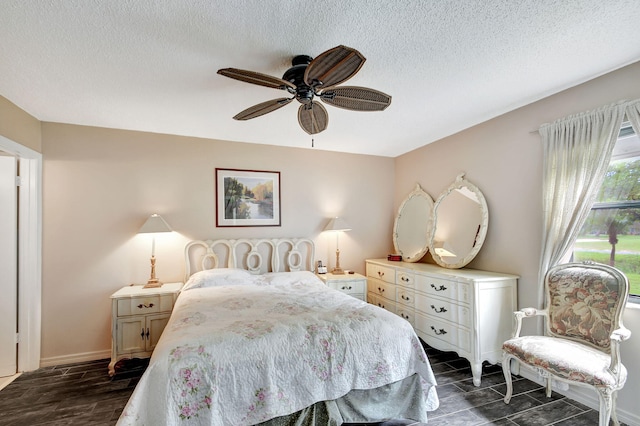 bedroom featuring a textured ceiling, dark hardwood / wood-style flooring, and ceiling fan