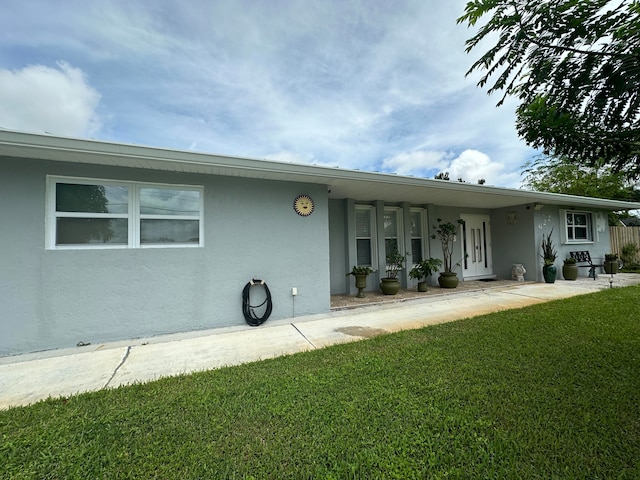 back of house featuring a yard and a patio