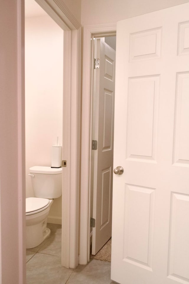 bathroom with toilet and tile patterned floors