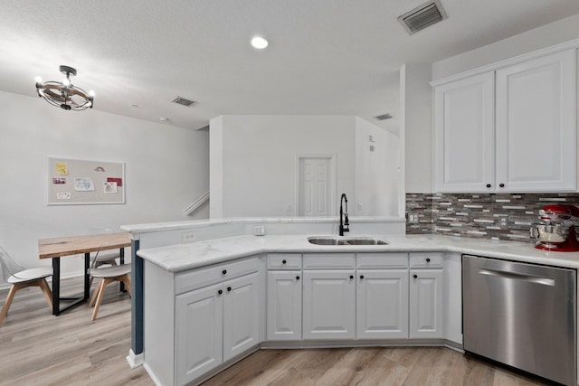 kitchen featuring dishwasher, sink, white cabinets, and light wood-type flooring