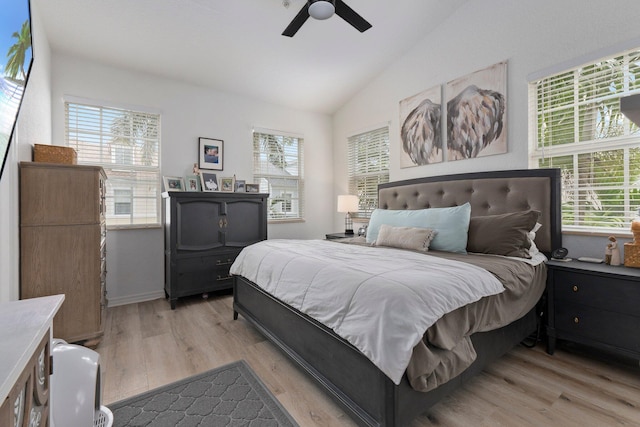 bedroom with vaulted ceiling, light hardwood / wood-style floors, and ceiling fan