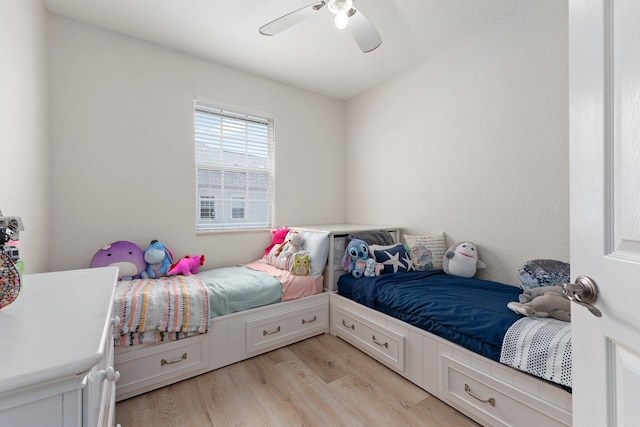 bedroom with ceiling fan and light hardwood / wood-style floors