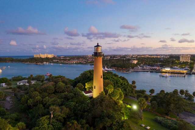 aerial view at dusk featuring a water view