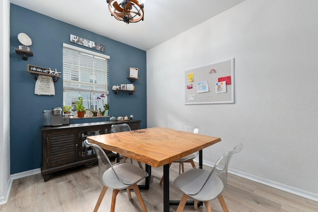 living room with ceiling fan and light hardwood / wood-style flooring