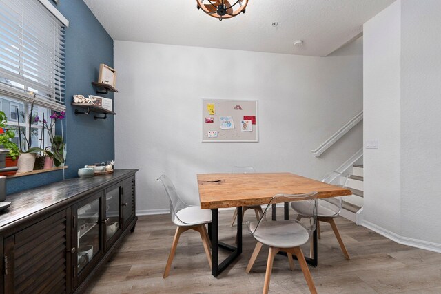 dining space with light hardwood / wood-style flooring