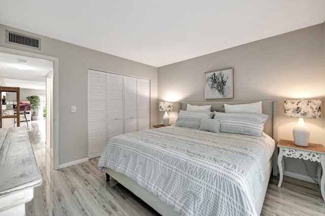 bedroom featuring light wood-type flooring and a closet