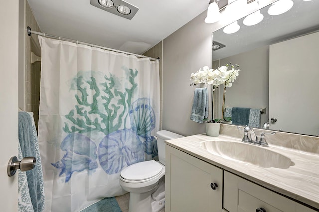 full bathroom with vanity, shower / tub combo, and toilet