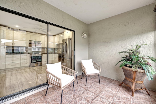 interior space featuring area for grilling and ceiling fan