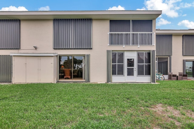 rear view of property with a lawn