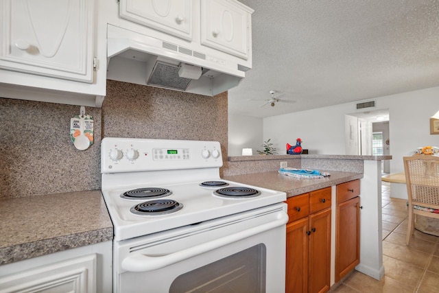 kitchen with tasteful backsplash, white cabinetry, a textured ceiling, and electric stove