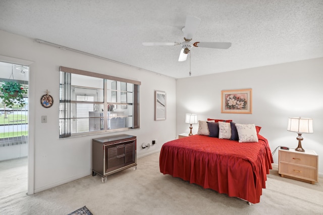 bedroom with light carpet, ceiling fan, access to outside, and a textured ceiling