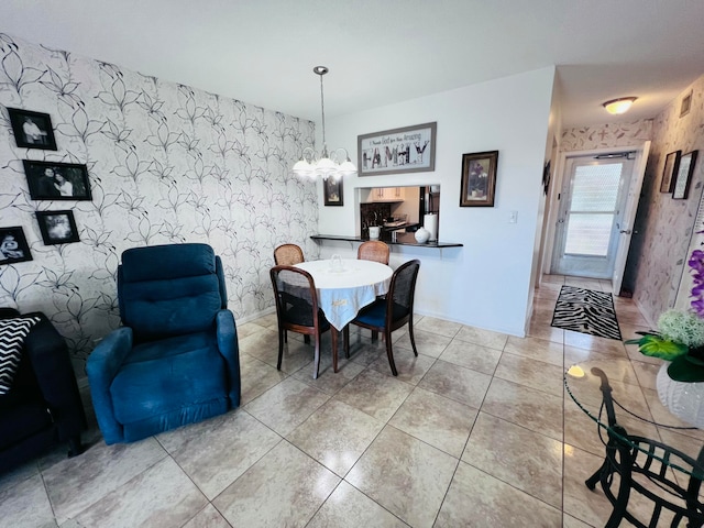 tiled dining space with a chandelier