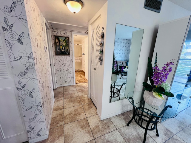 corridor featuring light tile patterned floors