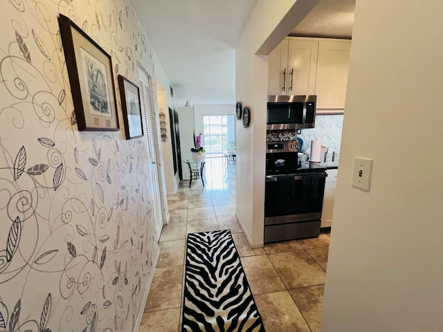 hallway featuring light tile patterned flooring