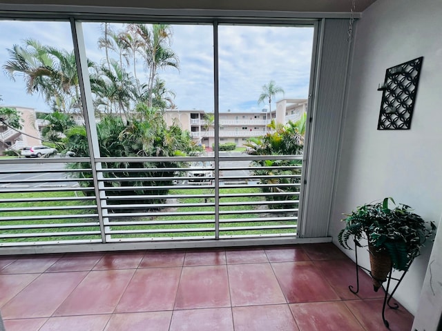 doorway to outside with tile patterned flooring