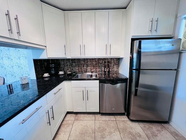 kitchen featuring backsplash, white cabinetry, sink, and appliances with stainless steel finishes