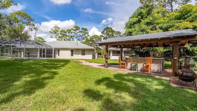 view of yard featuring a gazebo and a lanai