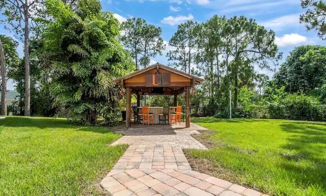 view of community with a lawn and a gazebo