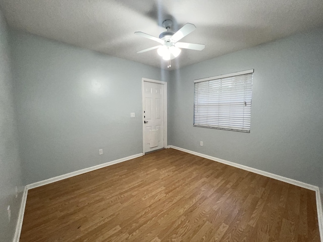 empty room featuring ceiling fan and hardwood / wood-style flooring