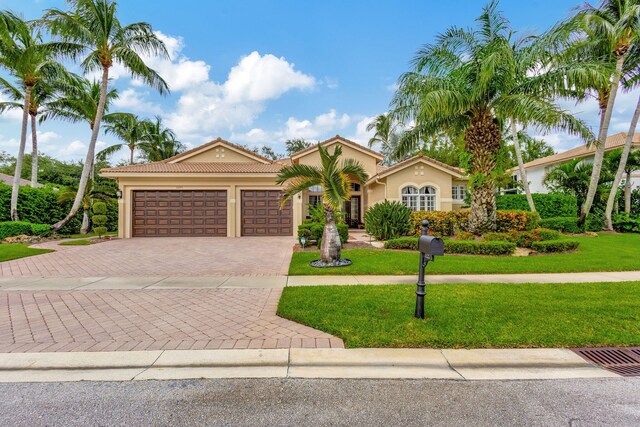 view of front of property with a garage and a front yard