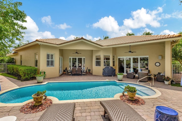 view of pool featuring an outdoor hangout area, ceiling fan, french doors, and a patio area