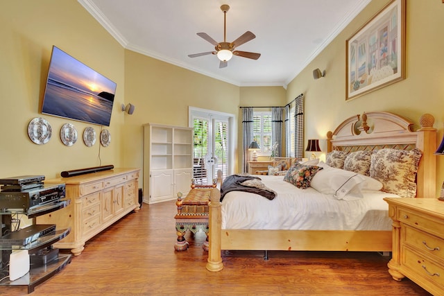 bedroom featuring light hardwood / wood-style flooring, ceiling fan, access to outside, and crown molding